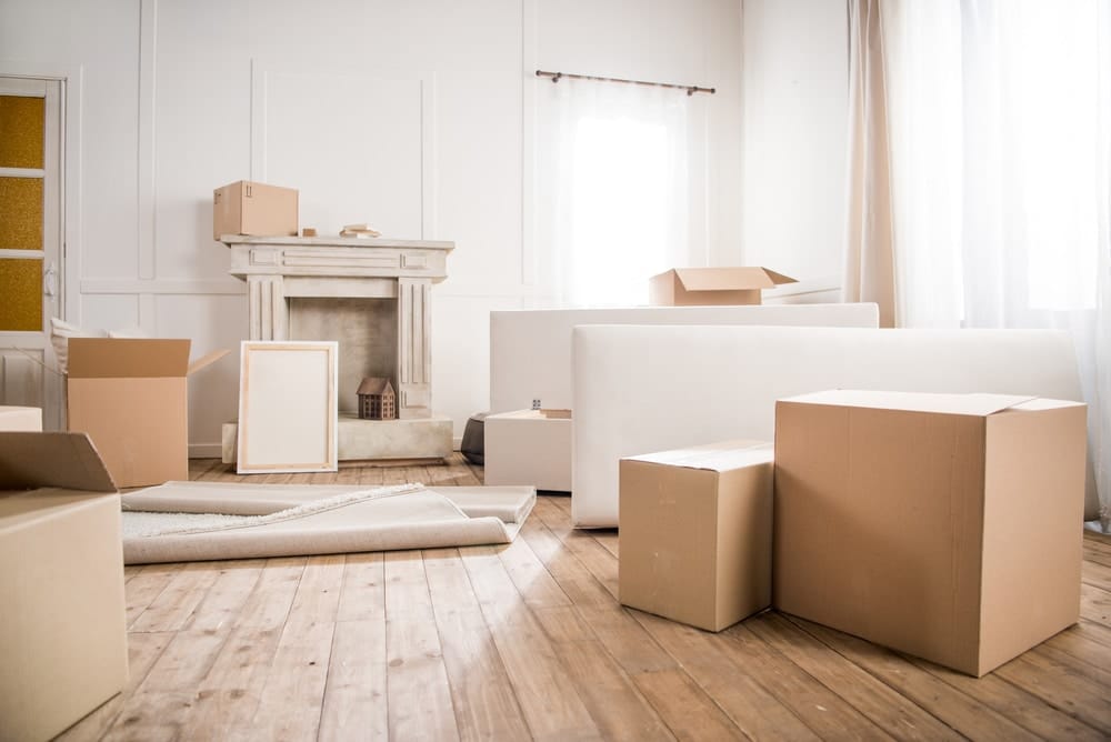 Living room with boxes and fireplace ready for removalists.